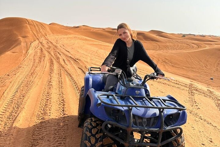 Experience the serene beauty of Dubai's Lahbab Red Dunes while riding an ATV across stunning landscapes perfect for adventurers and those seeking tranquility alike.